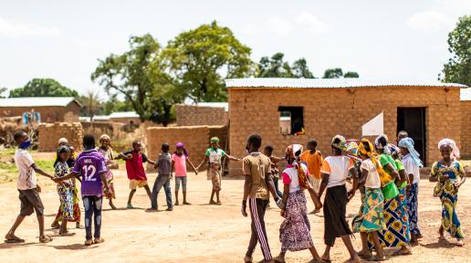 Un groupe d'apprenants bénéficiaires de la stratégie de scolarisation accélérée du projet Accel Africa de l’OIT jouent dehors dans une cour d'école. Région de Sikasso, au sud du Mali, juin 2021.